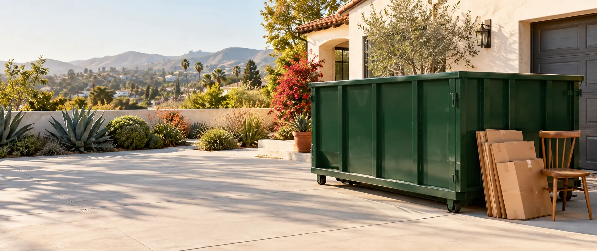 Illustrative green residential dumpster on a Los Angeles driveway